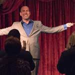 Magician Christopher Carter bowing on stage