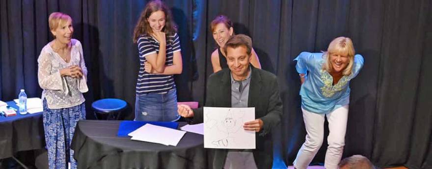 David Corsaro performing live in front of four laughing women