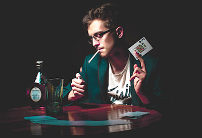 Man smoking while doing card trick
