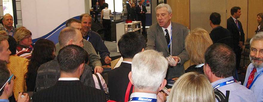 Harrison Carrol working his magic at a trade show, surrounded by people watching.