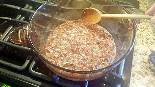 Mixing all the pecan praline ingredients over the fire