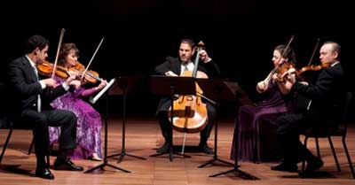 A wonderful chamber music evening with five musicians in beautiful costumes on stage.